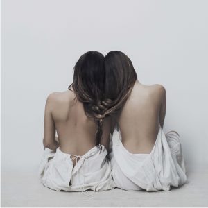 Two women with hair and shoulder together making a soul bound poster